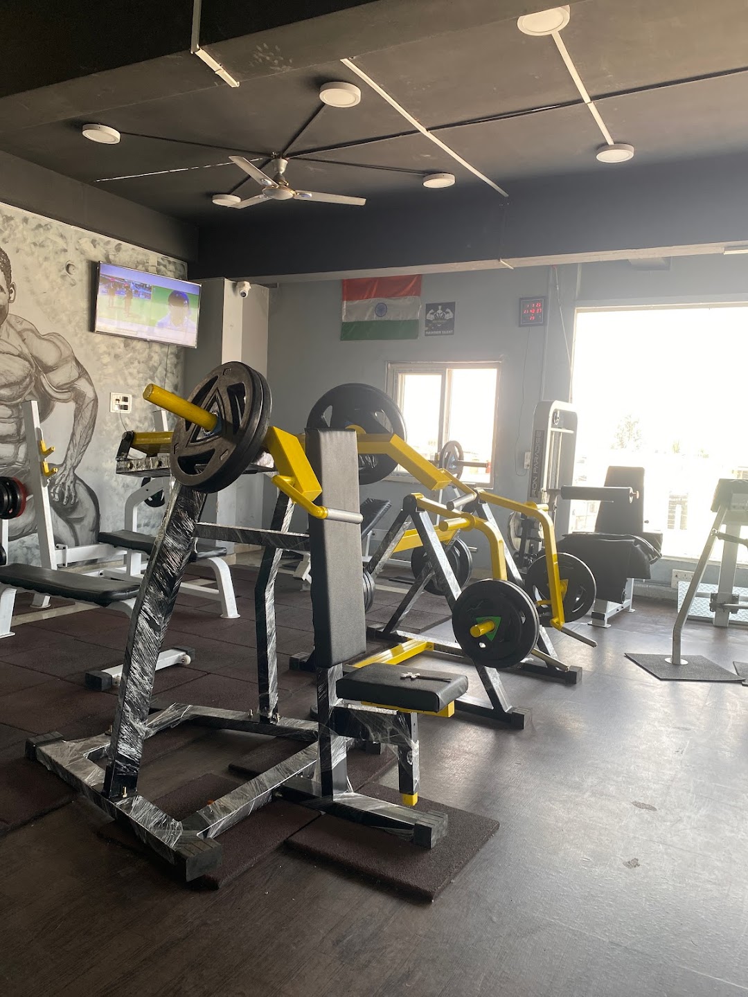 Bright and modern gym interior with various workout stations.